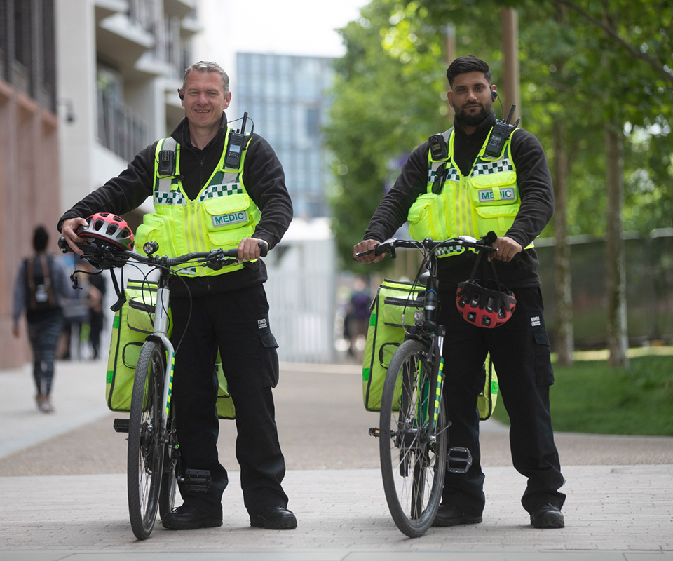 two security professionals holding bike