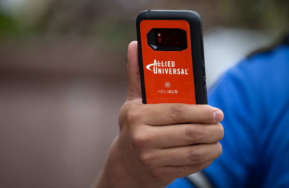 security guard holding heliaus device